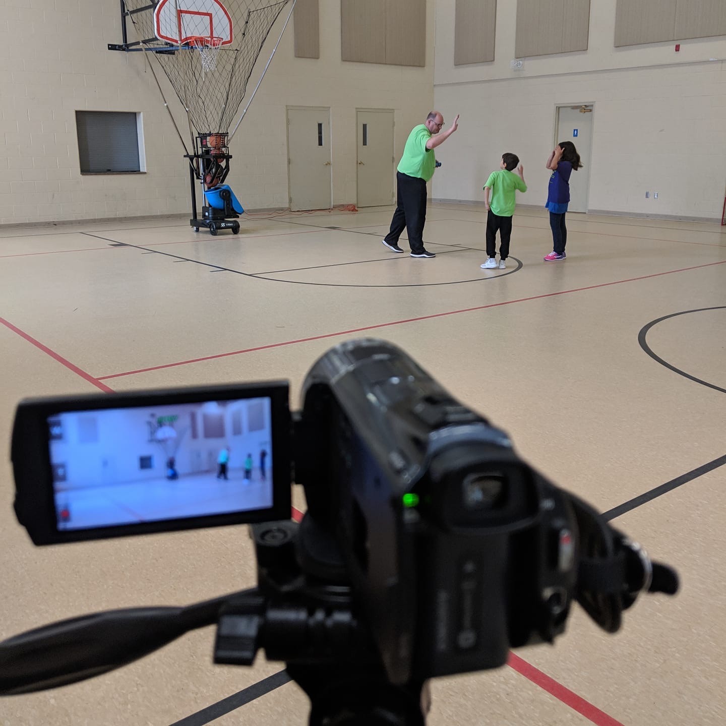 Coach Paul using VEKEDA basketball machine to train youth players in Canada.
