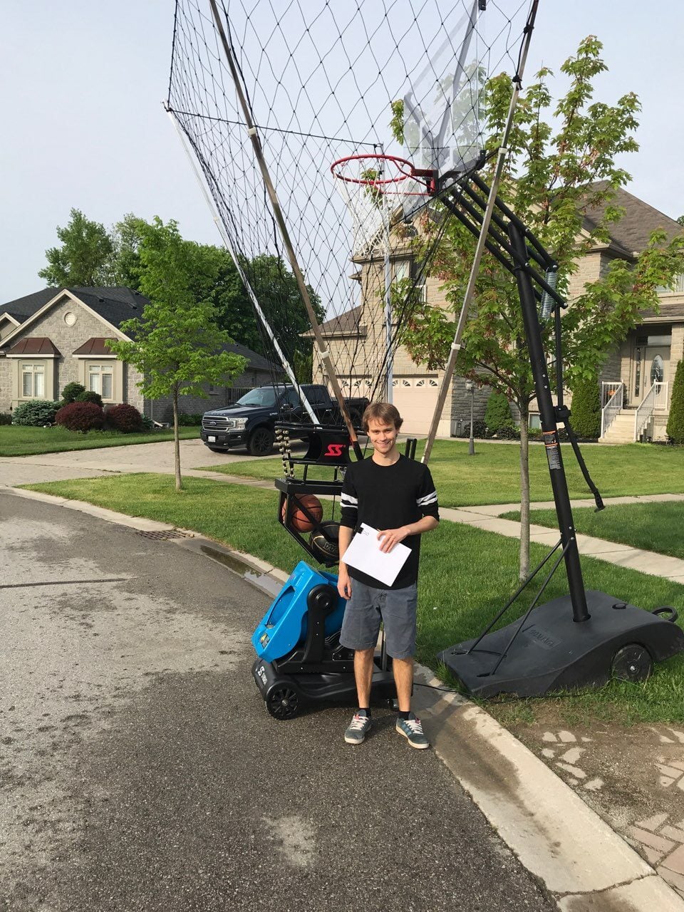 Canadian customer with VEKEDA K2100A basketball shooting machine at home